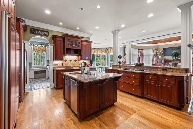 1465 New Columbia Hwy, Lewisburg, TN 37091 - kitchen featuring decorative columns, dark stone countertops, light wood-style flooring, stainless steel appliances, and a kitchen island with sink