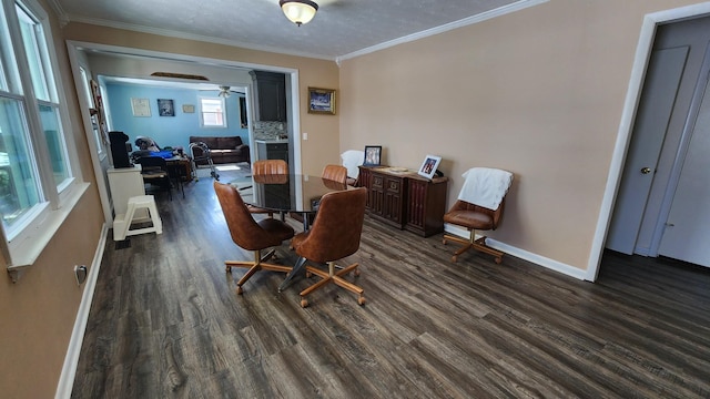 dining room featuring ornamental molding, dark wood-type flooring, and baseboards