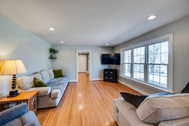 living room featuring recessed lighting, light wood-type flooring, and baseboards