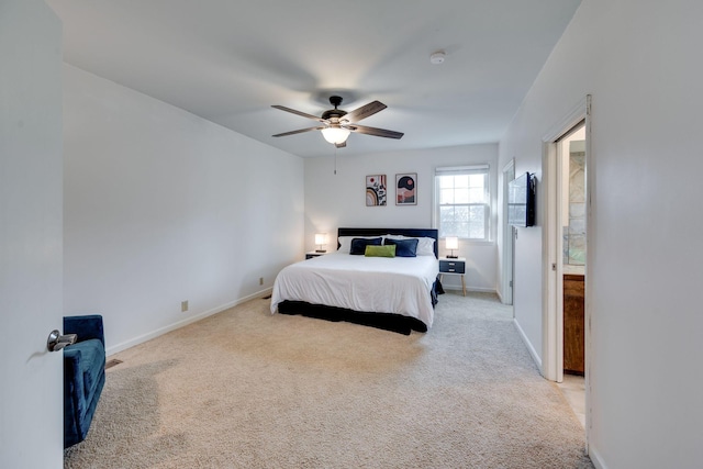 carpeted bedroom with ceiling fan and baseboards