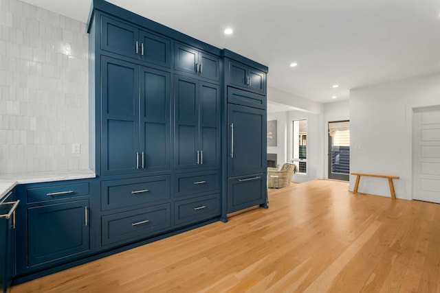 unfurnished living room featuring light wood-type flooring, a fireplace, and recessed lighting