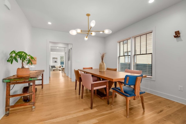 dining space featuring recessed lighting, baseboards, light wood finished floors, and an inviting chandelier