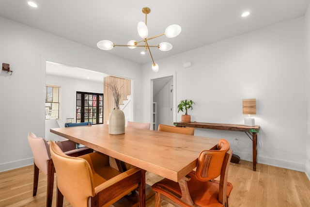 dining room with a chandelier, recessed lighting, light wood-style flooring, and baseboards