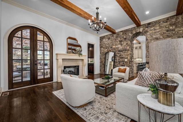 6054 Pelican Way, College Grove, TN 37046 - living room featuring arched walkways, wood-type flooring, beamed ceiling, a chandelier, and a fireplace