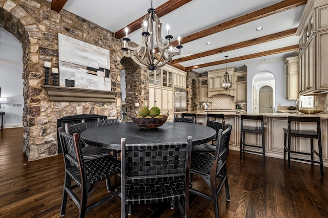 6054 Pelican Way, College Grove, TN 37046 - dining room featuring arched walkways, dark wood-style flooring, a chandelier, beamed ceiling, and a fireplace