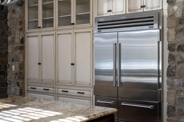 6054 Pelican Way, College Grove, TN 37046 - kitchen featuring high end refrigerator, cream cabinetry, and glass insert cabinets