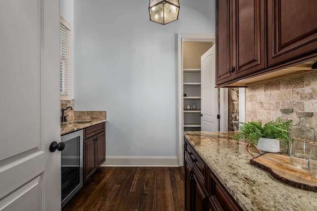 6054 Pelican Way, College Grove, TN 37046 - kitchen with tasteful backsplash, light stone countertops, dark wood-style flooring, and dark brown cabinetry