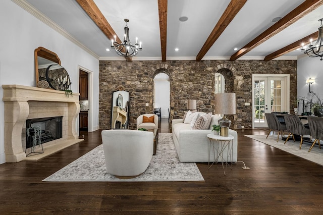 6054 Pelican Way, College Grove, TN 37046 - living area with a chandelier, arched walkways, beamed ceiling, a fireplace with raised hearth, and wood finished floors