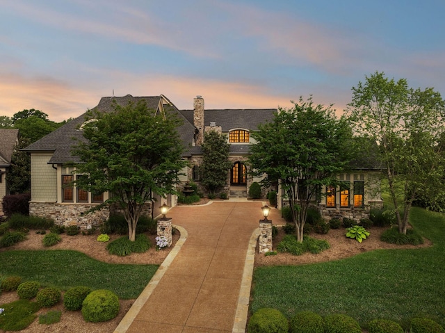 6054 Pelican Way, College Grove, TN 37046 - french provincial home with stone siding, concrete driveway, french doors, and a chimney