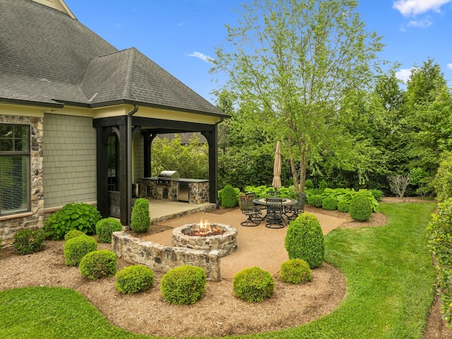 6054 Pelican Way, College Grove, TN 37046 - view of grassy yard with an outdoor fire pit, an outdoor kitchen, and a patio area