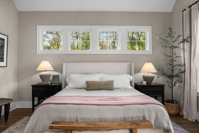 bedroom featuring baseboards and dark wood finished floors