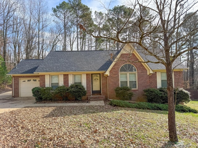 ranch-style home with a garage, driveway, roof with shingles, and brick siding