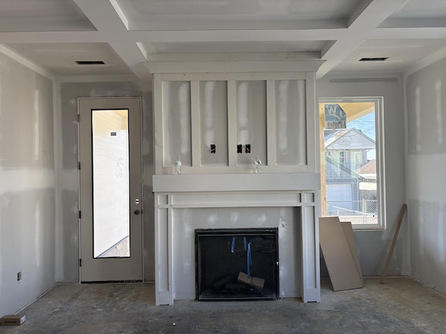 unfurnished living room with a glass covered fireplace, beam ceiling, and coffered ceiling