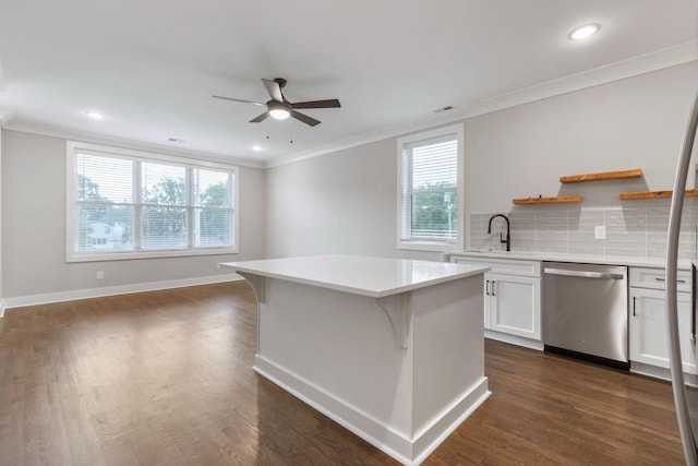 kitchen with open shelves, light countertops, stainless steel dishwasher, white cabinets, and a sink