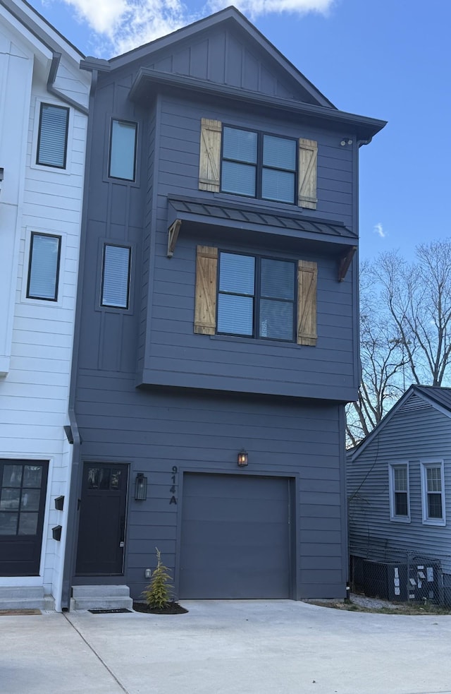 view of front of property featuring board and batten siding, concrete driveway, and a garage