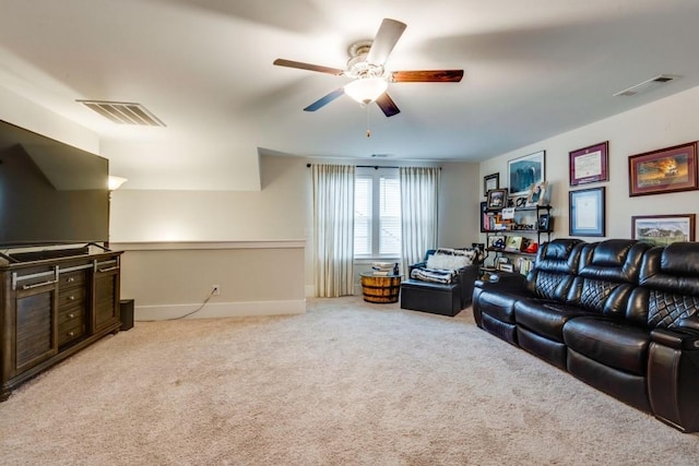 living area featuring baseboards, visible vents, and light colored carpet