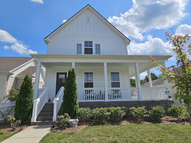 farmhouse featuring a porch and board and batten siding