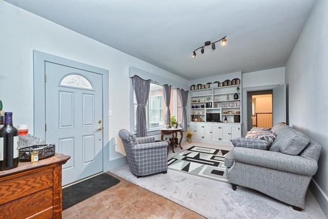 entryway featuring rail lighting and carpet flooring