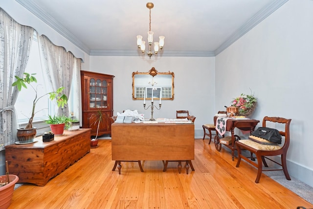 interior space with light wood-type flooring, an inviting chandelier, baseboards, and ornamental molding