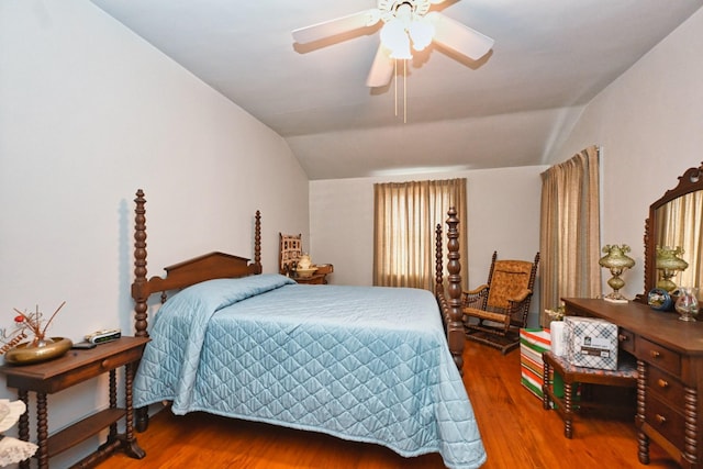 bedroom with vaulted ceiling, ceiling fan, and wood finished floors