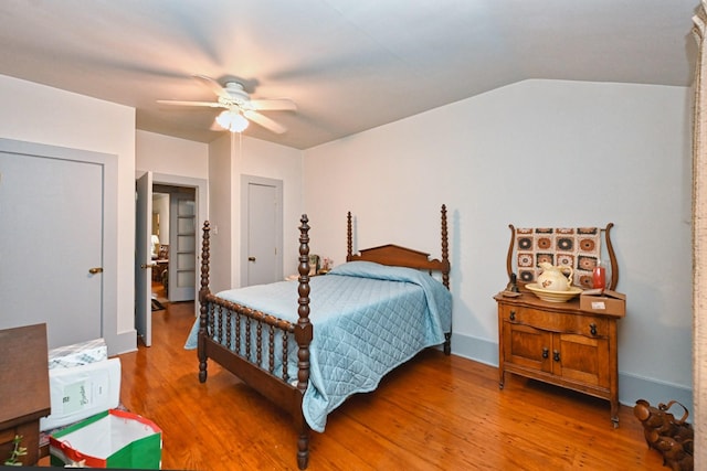 bedroom with lofted ceiling, ceiling fan, and wood finished floors