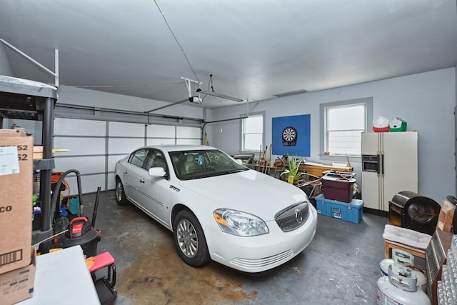 garage with white fridge with ice dispenser