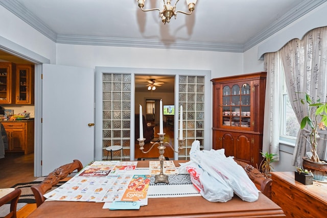 dining space featuring ornamental molding and an inviting chandelier