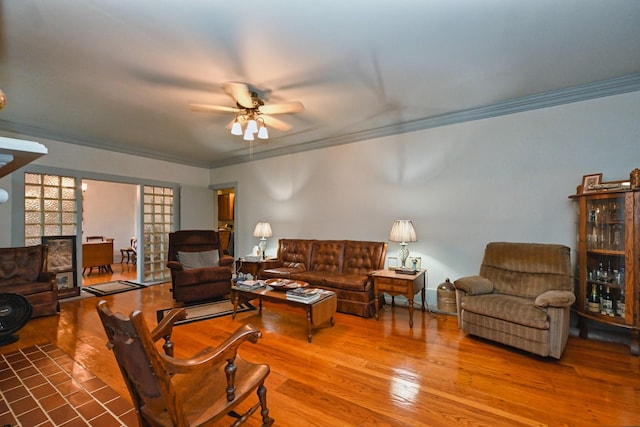 living area featuring ornamental molding, ceiling fan, and wood finished floors