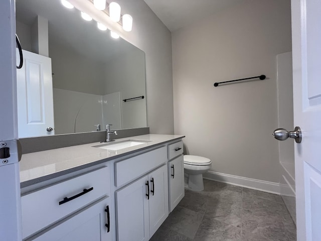 full bath featuring toilet, baseboards, walk in shower, and vanity