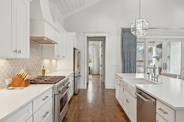 kitchen with white cabinetry, custom exhaust hood, light countertops, and premium appliances