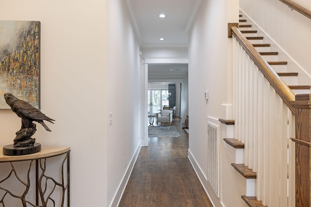 corridor featuring baseboards, dark wood-style flooring, stairs, crown molding, and recessed lighting