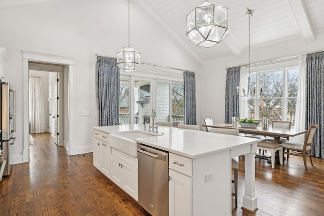 kitchen with a chandelier, stainless steel appliances, white cabinets, an island with sink, and decorative light fixtures