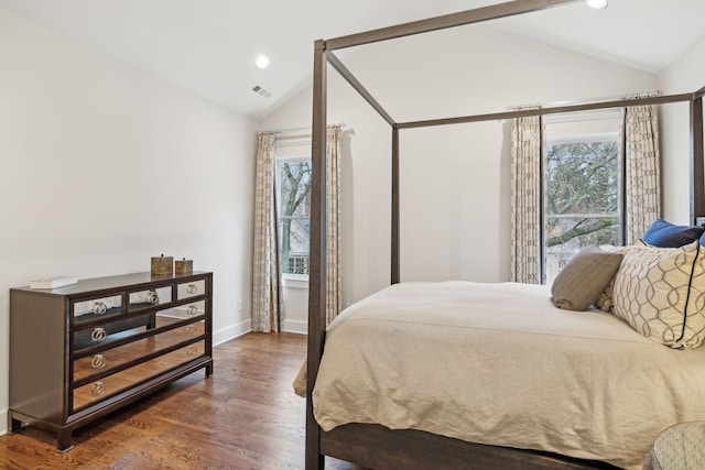 bedroom with dark wood-style floors, recessed lighting, visible vents, and vaulted ceiling