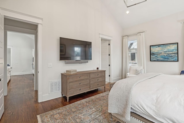 bedroom featuring baseboards, visible vents, vaulted ceiling, and dark wood-type flooring