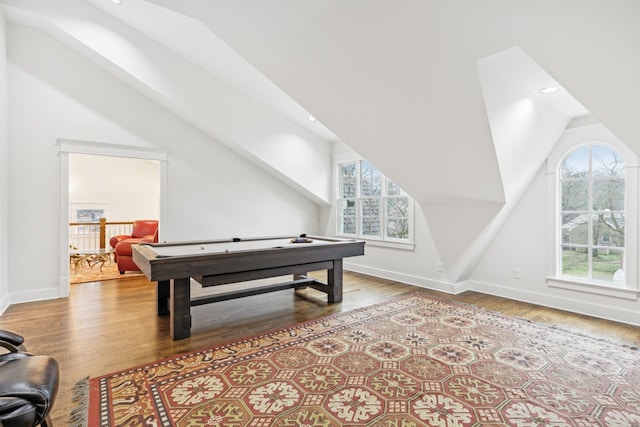 rec room featuring vaulted ceiling, light wood finished floors, and a healthy amount of sunlight