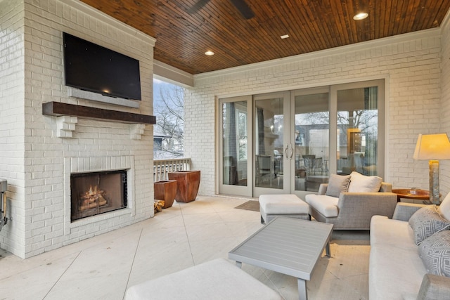 view of patio / terrace with an outdoor brick fireplace and french doors