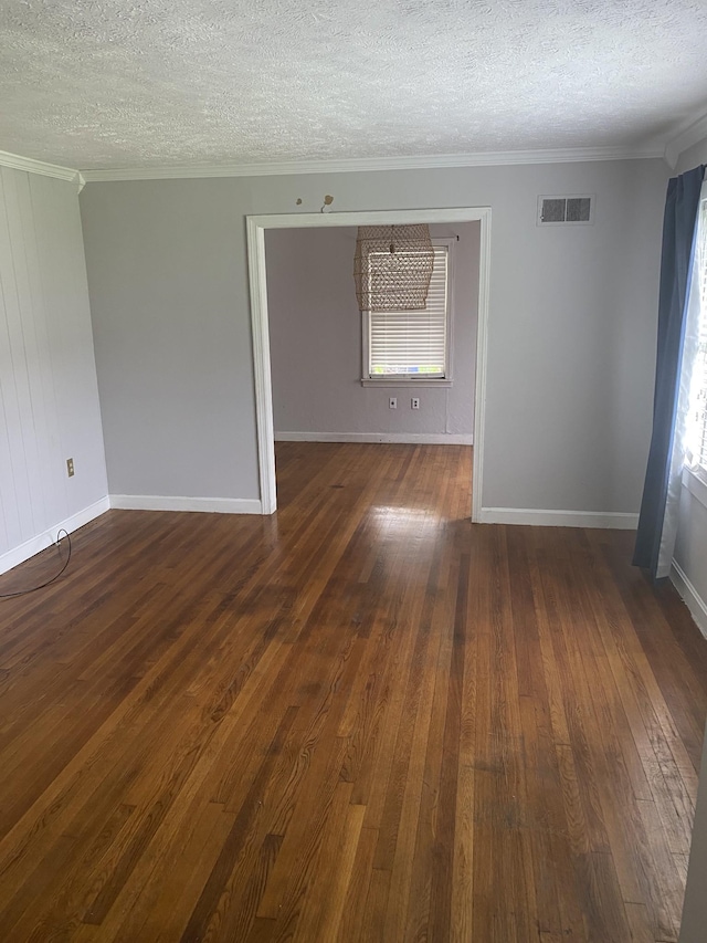 spare room featuring ornamental molding, visible vents, and a healthy amount of sunlight