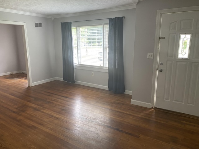 entryway with dark wood-style floors, visible vents, ornamental molding, and a textured ceiling