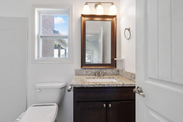 bathroom featuring toilet and vanity