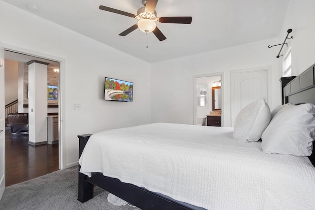 bedroom with baseboards, ceiling fan, and ensuite bath