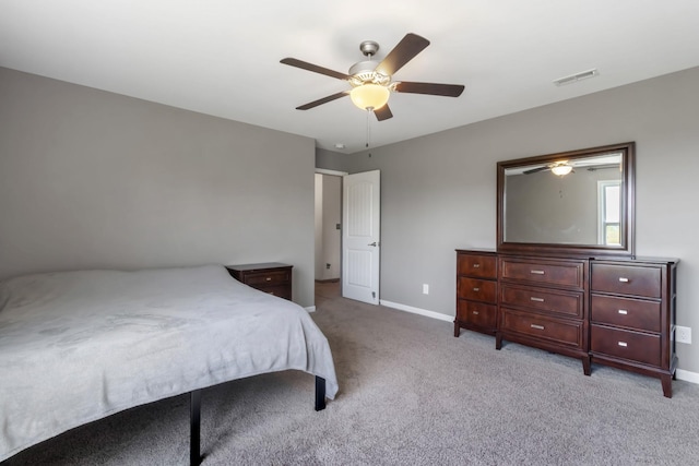 bedroom with light carpet, baseboards, visible vents, and a ceiling fan