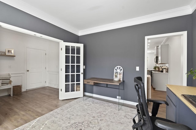 office area with baseboards, light wood-style flooring, and crown molding