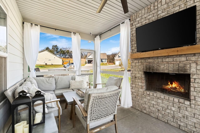 view of patio / terrace featuring a ceiling fan, a residential view, and an outdoor living space with a fireplace