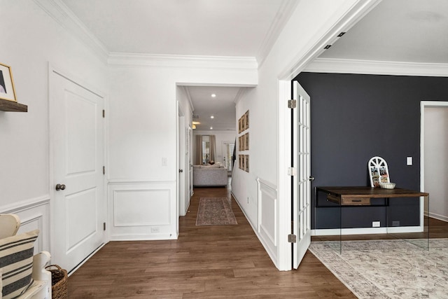 corridor featuring dark wood-style floors, crown molding, and a decorative wall