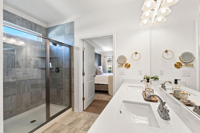 bathroom featuring a stall shower, a sink, and ensuite bathroom