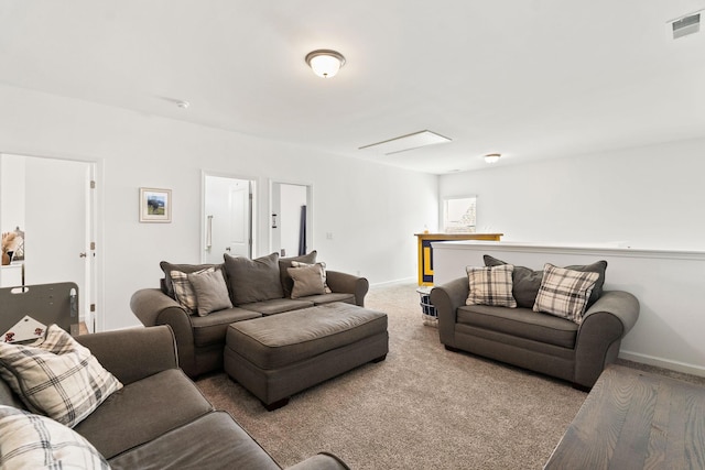 living area with carpet flooring, visible vents, and baseboards