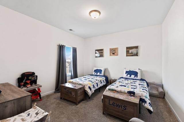 bedroom with baseboards, visible vents, and dark carpet