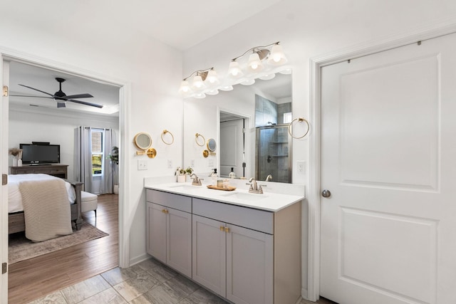 full bath featuring a sink, connected bathroom, a ceiling fan, and a shower stall