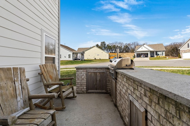 view of patio with area for grilling and a residential view