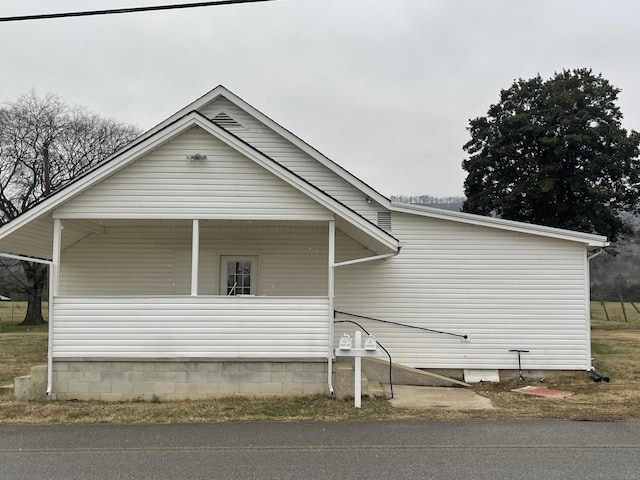 view of side of home with covered porch